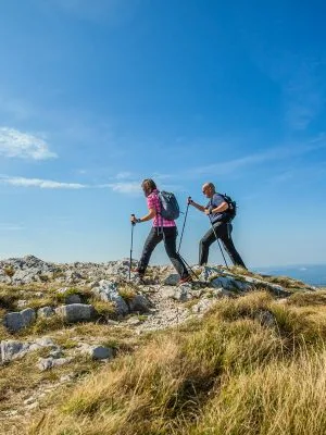 Hpd 0000s 0006 couple hiking nanos plateau slovenia against blue sky pvwjg23t7xqlb6inolpltqvy1z8n523zb8jbpfksyo